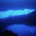 Malta Divers going through a hole