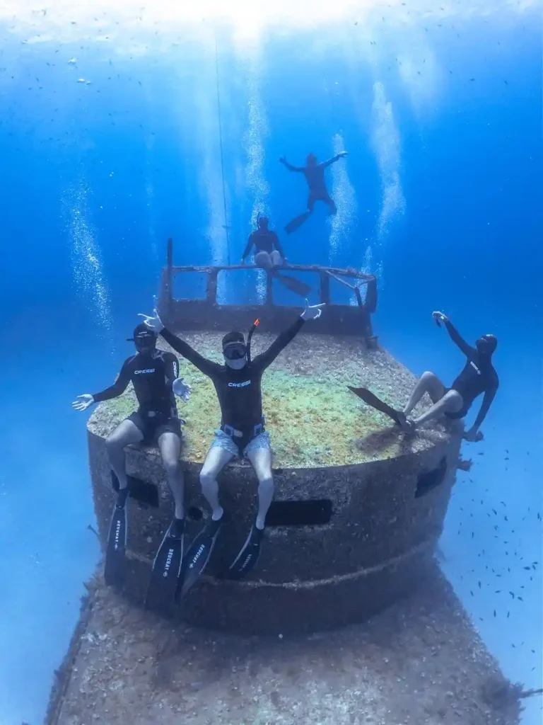 A group of friends free diving and hanging out on a boat in Malta.