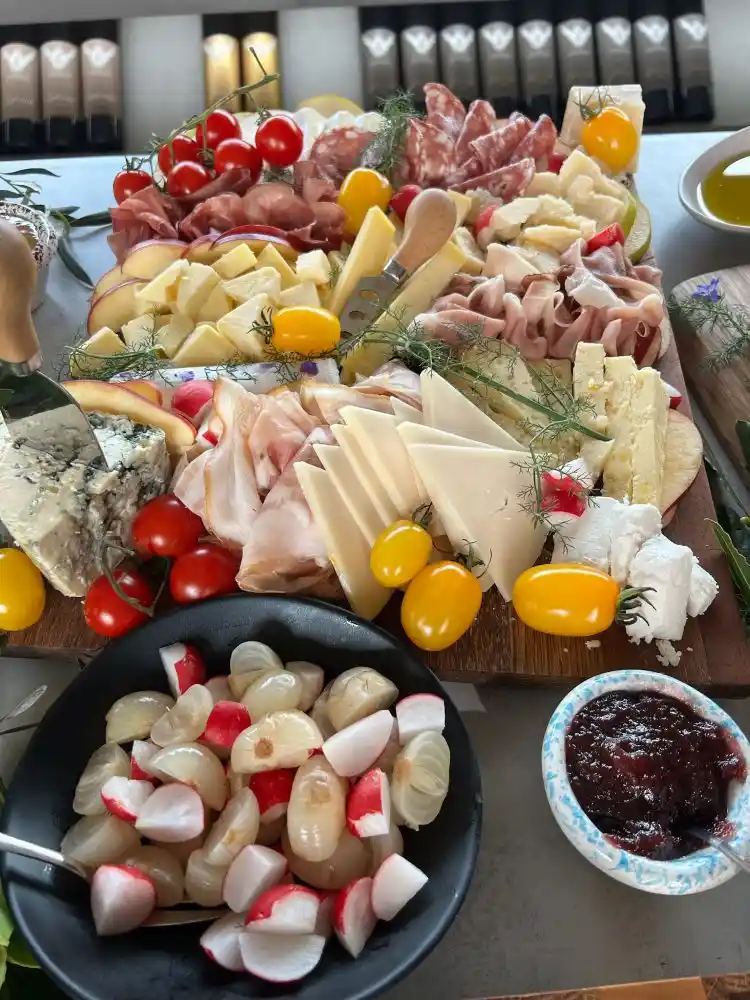 A platter of local cheese, tomatoes and cured meat served alongside a Markus Divinus wine tasting