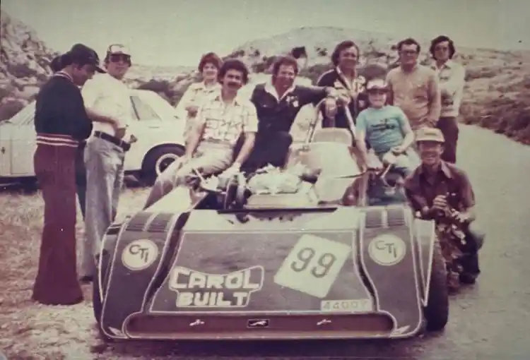 A group posing with a custom-built Maltese hillclimb or racing special marked “Carol Built” and “CTI,” likely photographed during a local motorsport event in Malta in the 1970s.